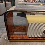 Architectural TV Stand with Sculpted Relief Panels Natural Wood Veneer Open Display Shelves and Soft Ambient Lighting